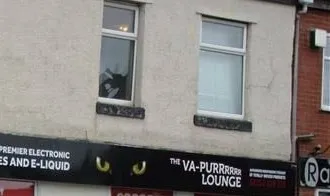 The Chorley shop sign on Bolton Street: the black fascia with the amber cat eyes and "The Va-Purrrrr Lounge"